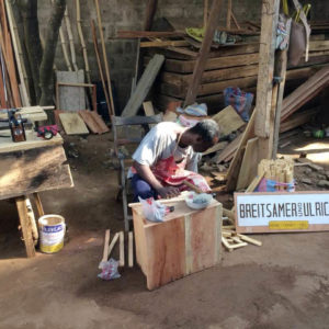 A man builds bee hives in Togo