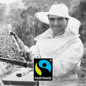 Fairtrade beekeeper with honeycomb in hand and Fairtrade logo